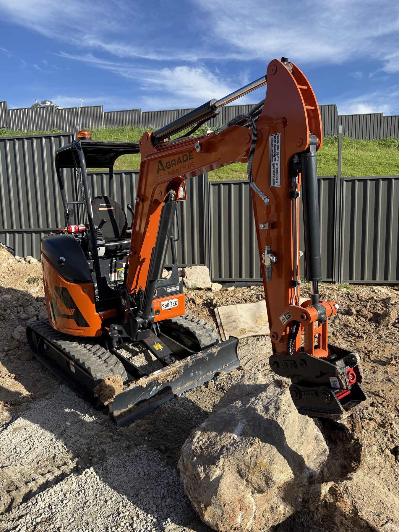Moving rocks for landscaping with a mini excavator